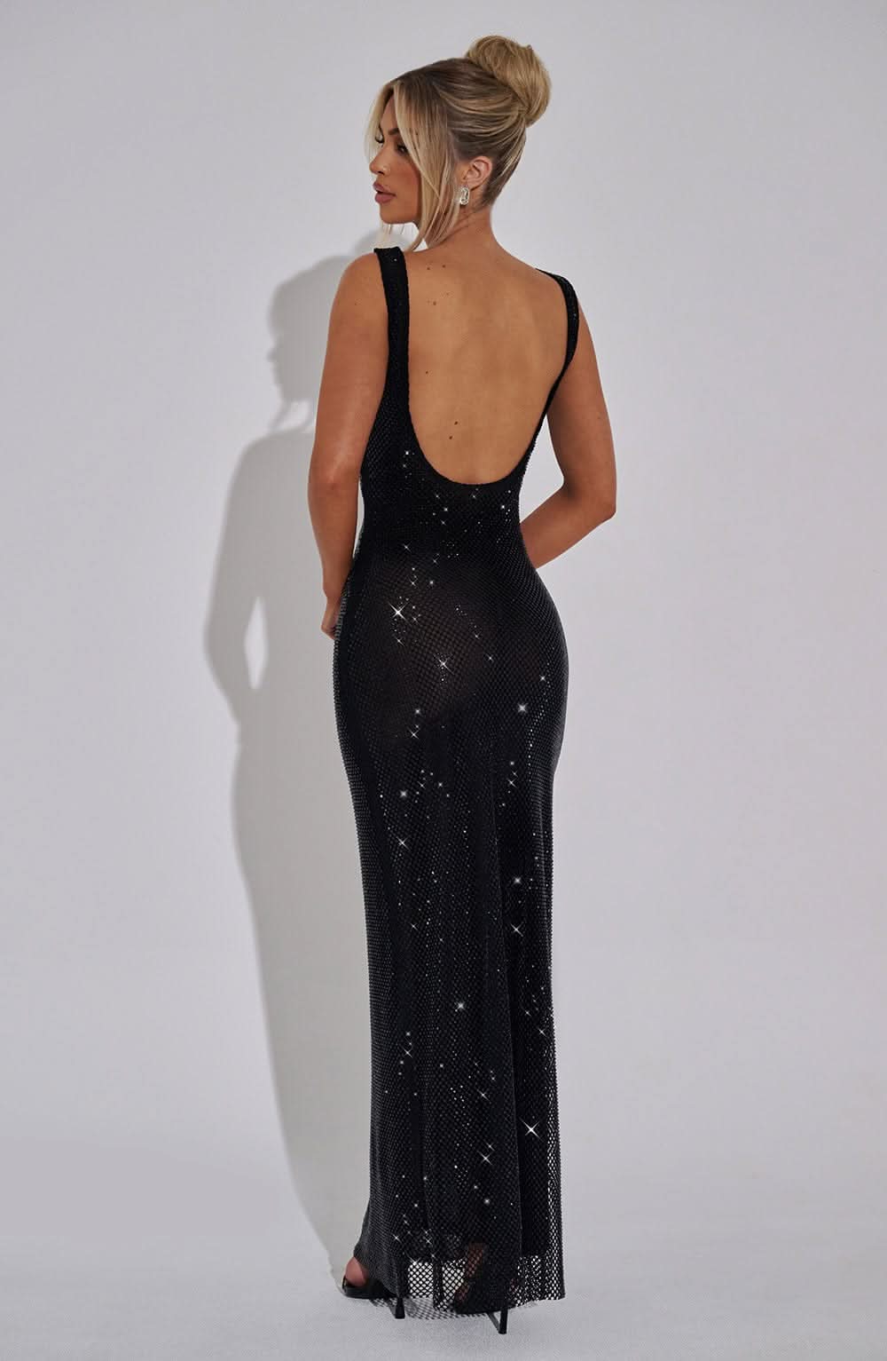 Back view of black sparkly maxi dress with low open back