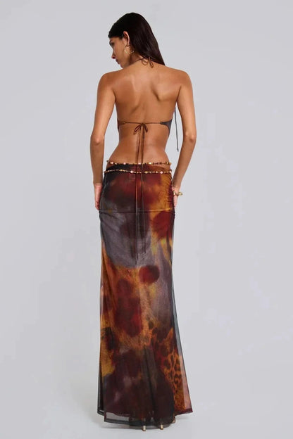 Backless halter maxi dress showing ties and beaded waist chain embellishment