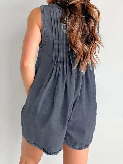 Dark gray denim romper back view with vertical pleating and side pockets