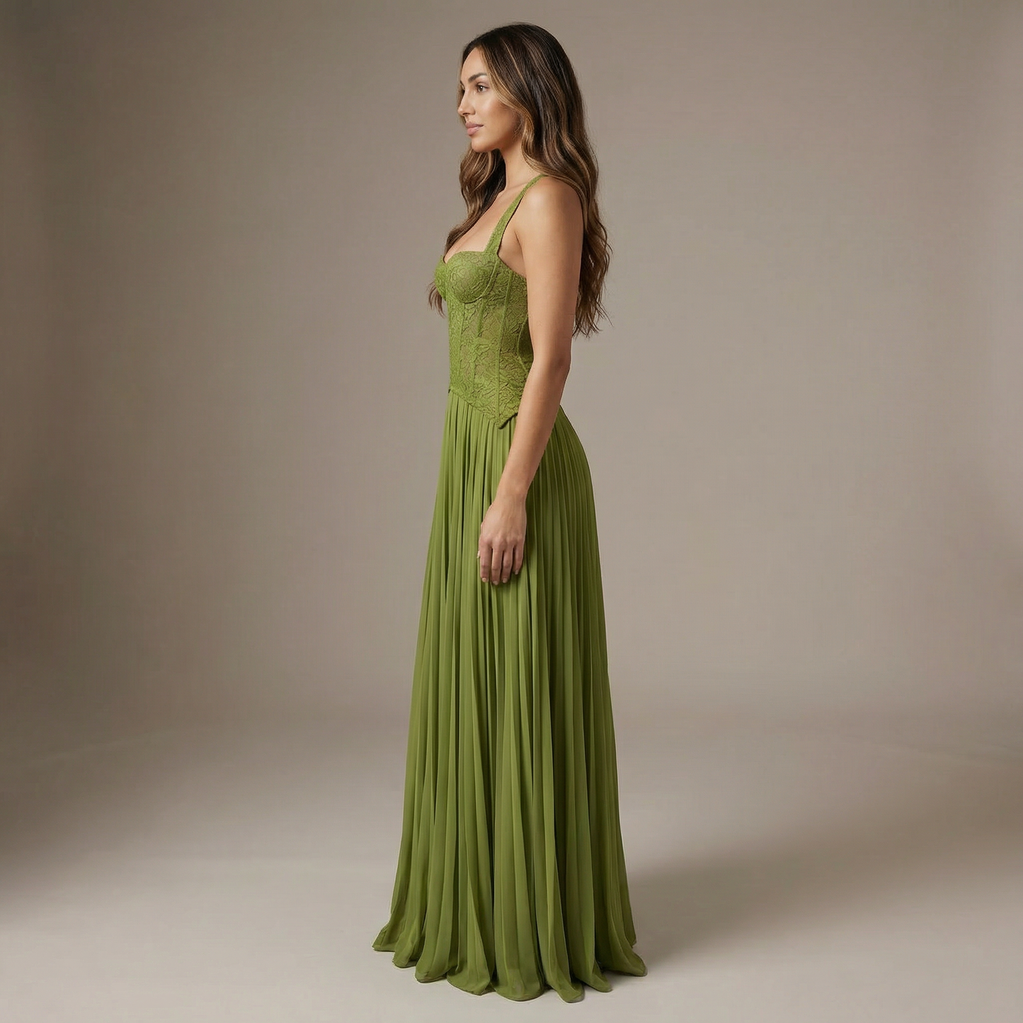 Side view of women's lime green maxi dress showing structured lace bodice and flowing pleated skirt