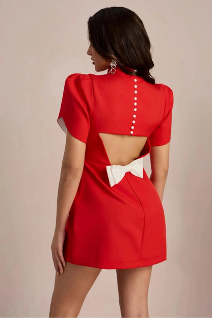 Red mini dress back view showing open cutout and white bow accent