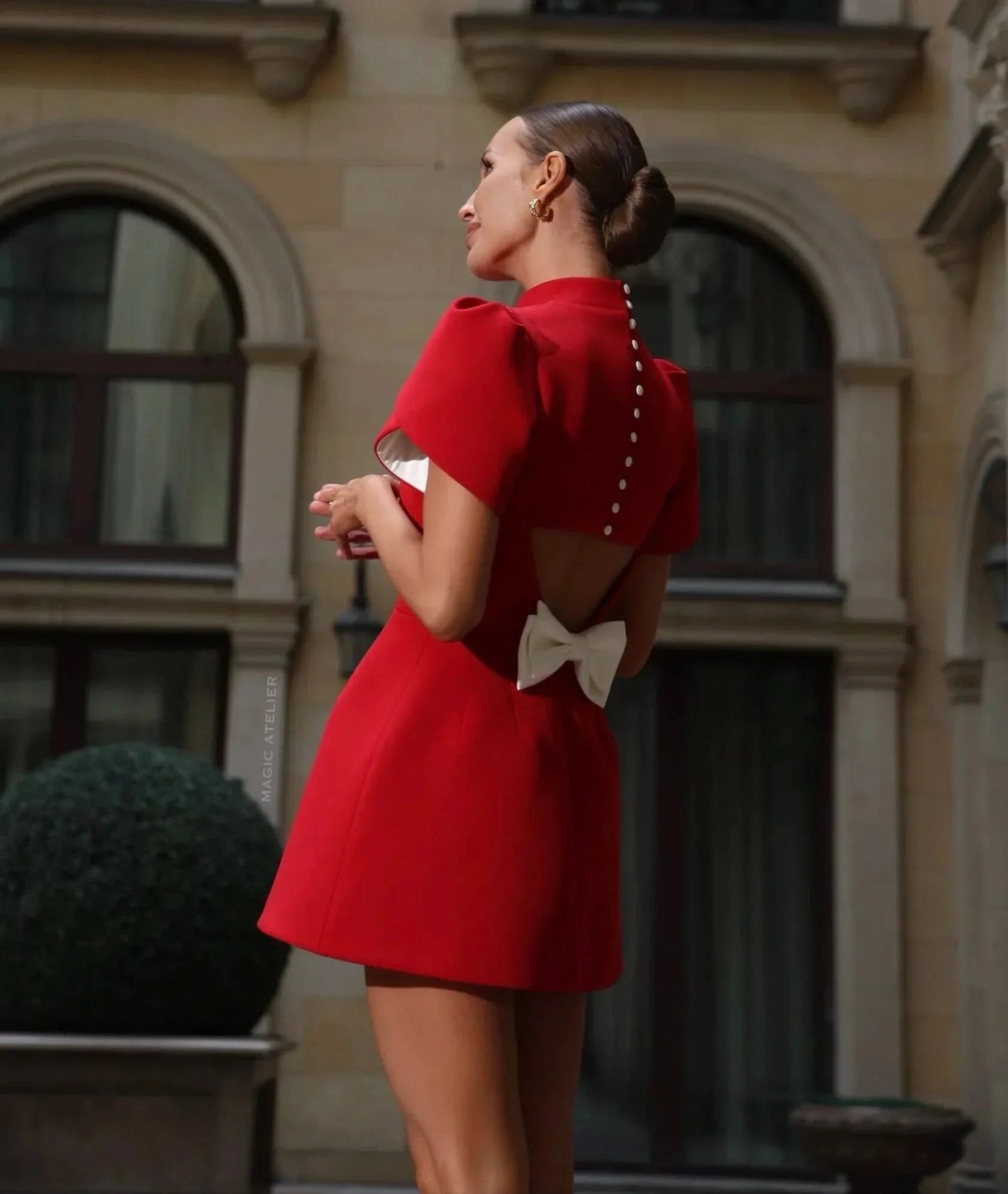 Red mini dress with puffed sleeves worn outdoors
