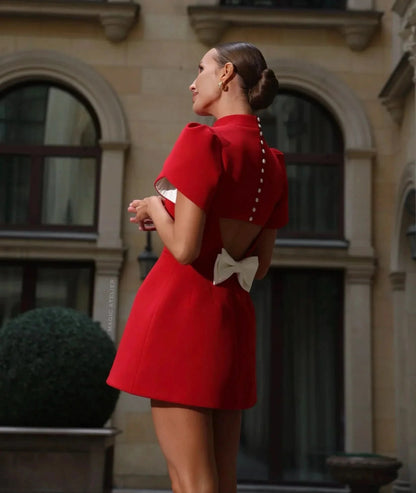 Red mini dress with puffed sleeves worn outdoors
