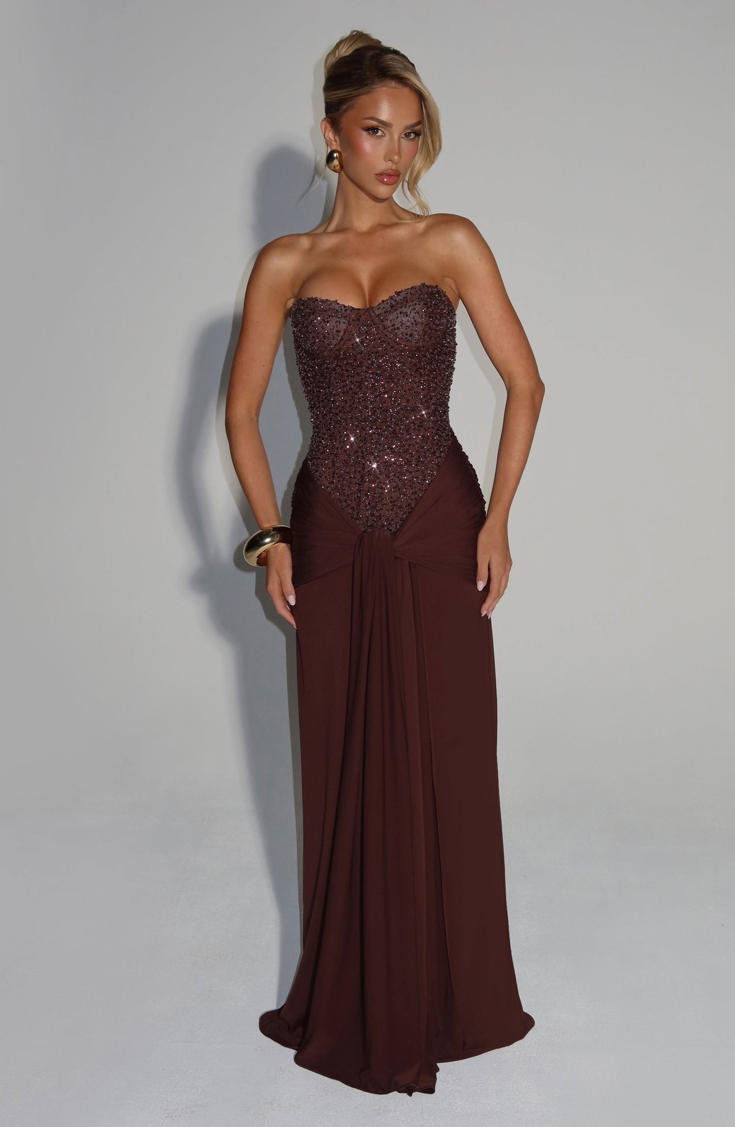 Chocolate brown beaded strapless maxi dress with sweetheart neckline and flowing skirt