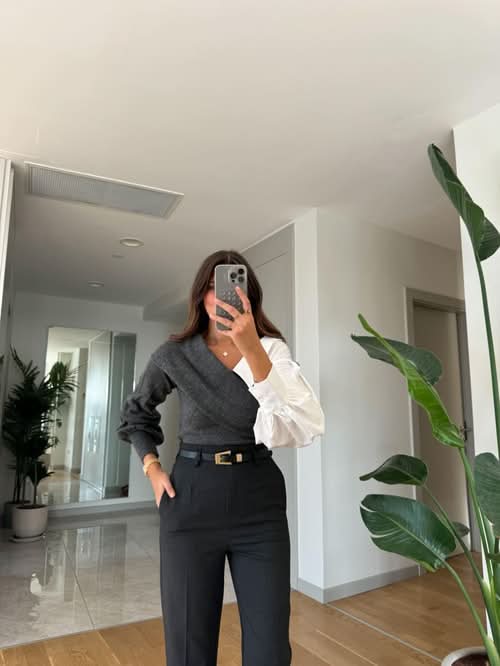 Charcoal gray and white two-tone sweater with white puffy sleeves and belt detail