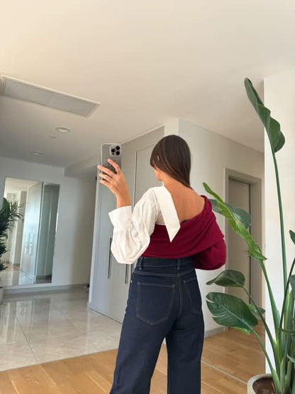 Charcoal gray and white two-tone sweater with white puffy sleeves and belt detail