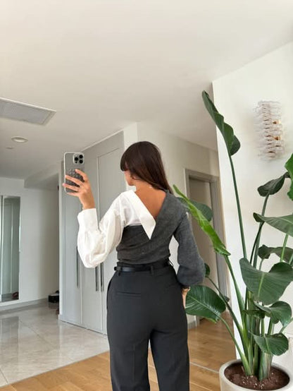 Gray and white two-tone sweater with white ruched sleeves and wrap neckline