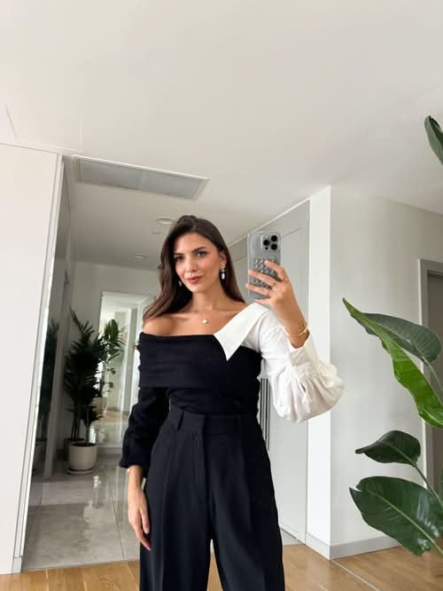 Two-tone sweater with white puffy sleeves and black off-shoulder body