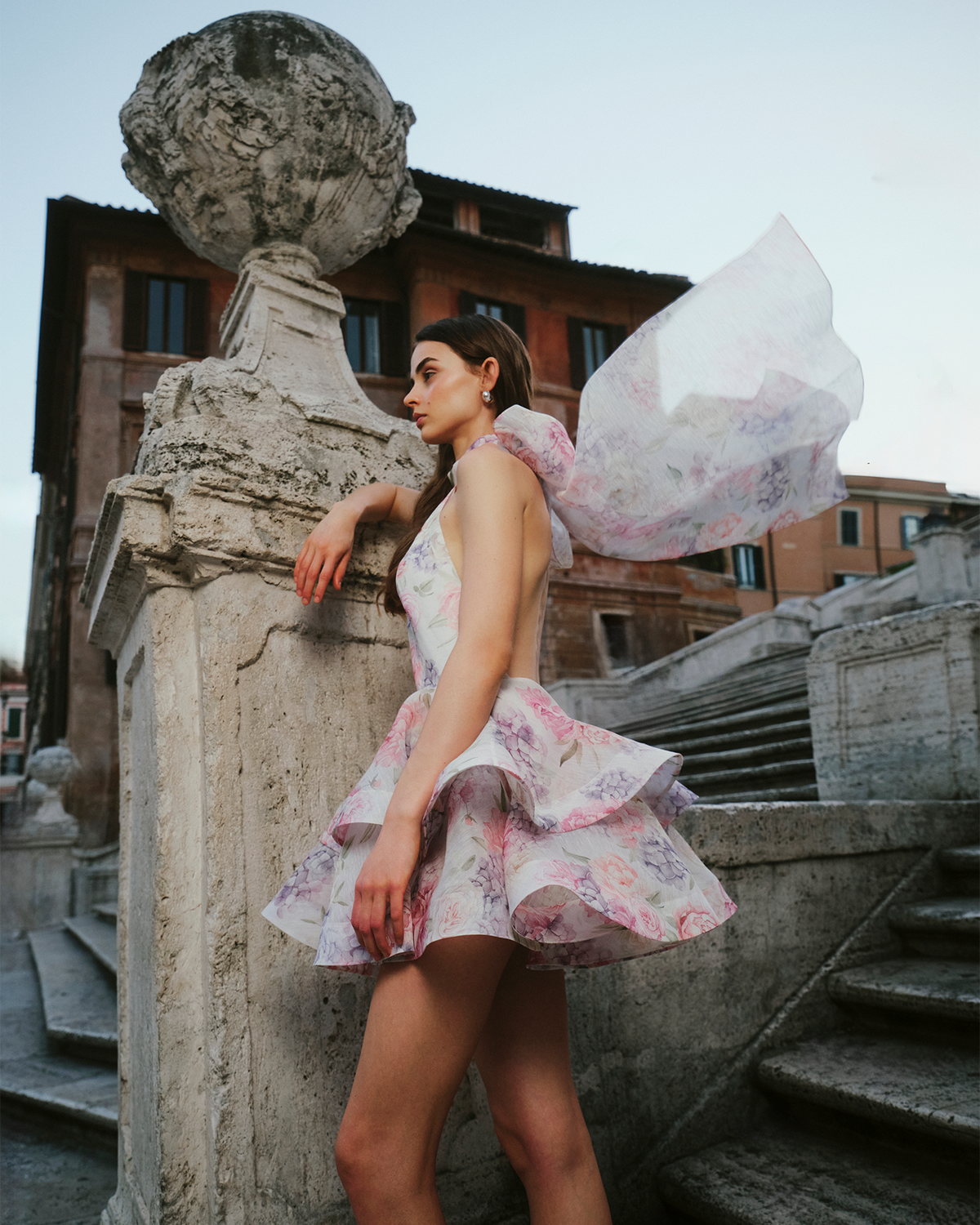 Side view of floral mini dress showing layered ruffled skirt and open back design