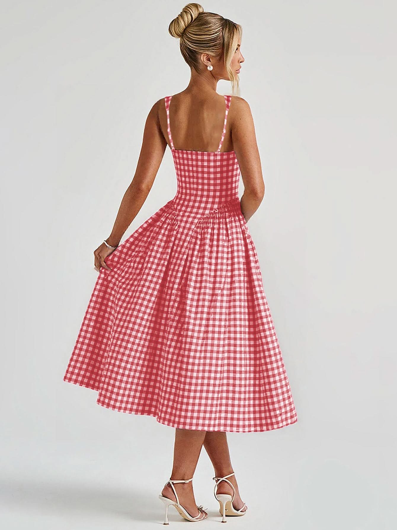 Back view of red gingham midi dress with thin straps and flowing skirt