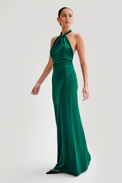 Close-up of twisted halter neckline on emerald maxi dress