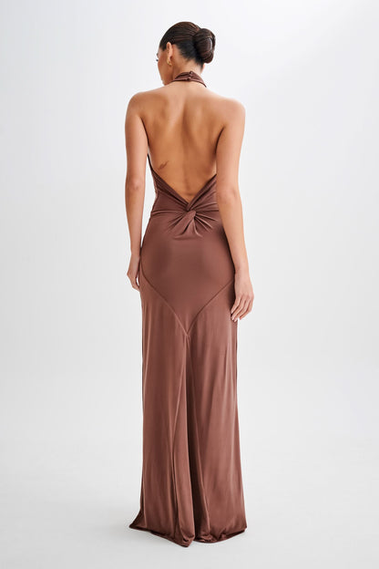 Side profile of taupe halter maxi dress with flowing train
