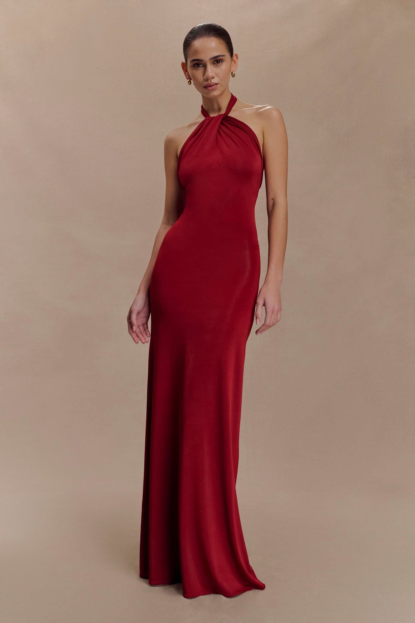 Deep red halter maxi dress with gathered neckline and fitted bodice