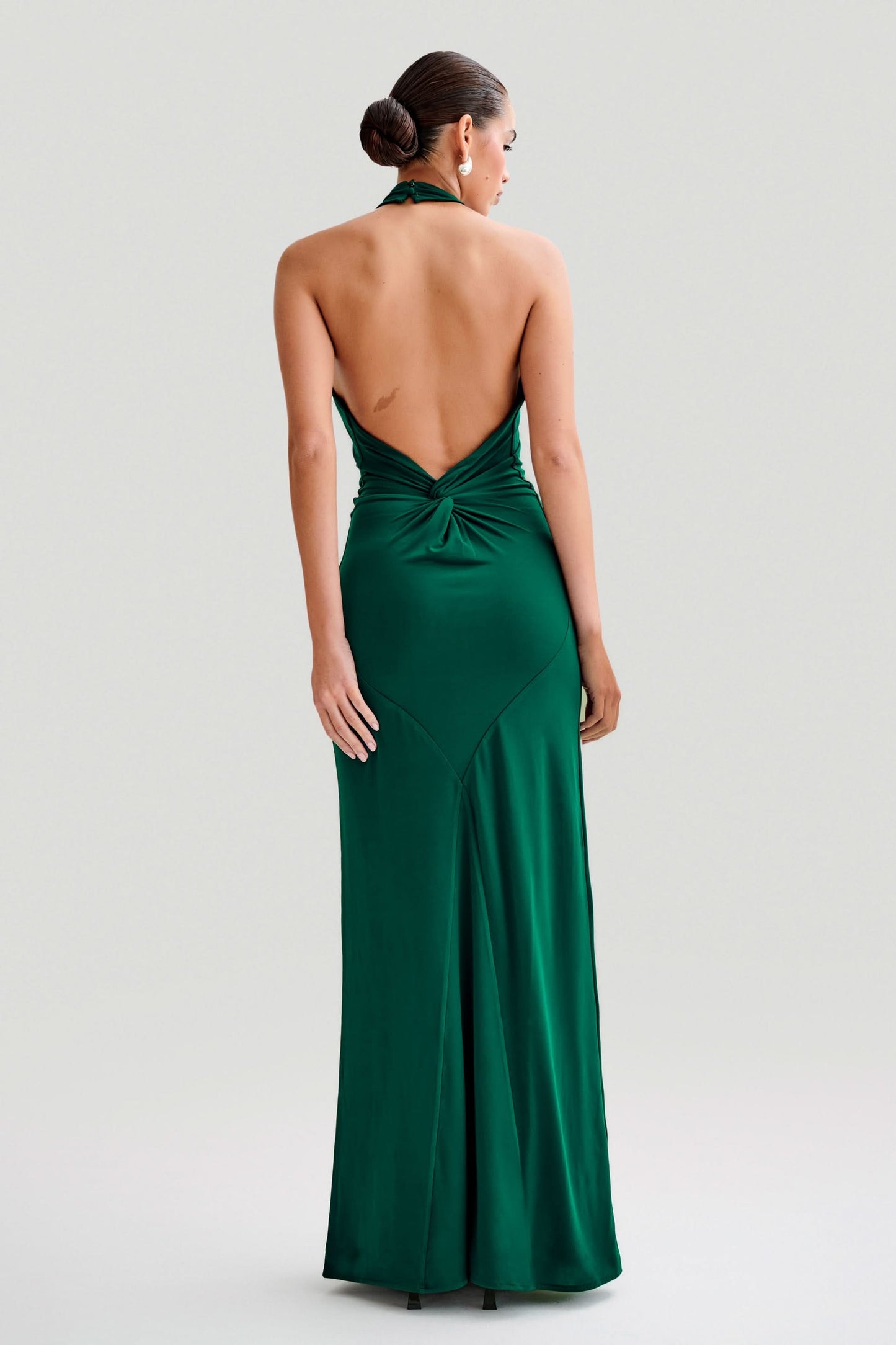 Emerald green halter maxi dress back view with twisted backless cut