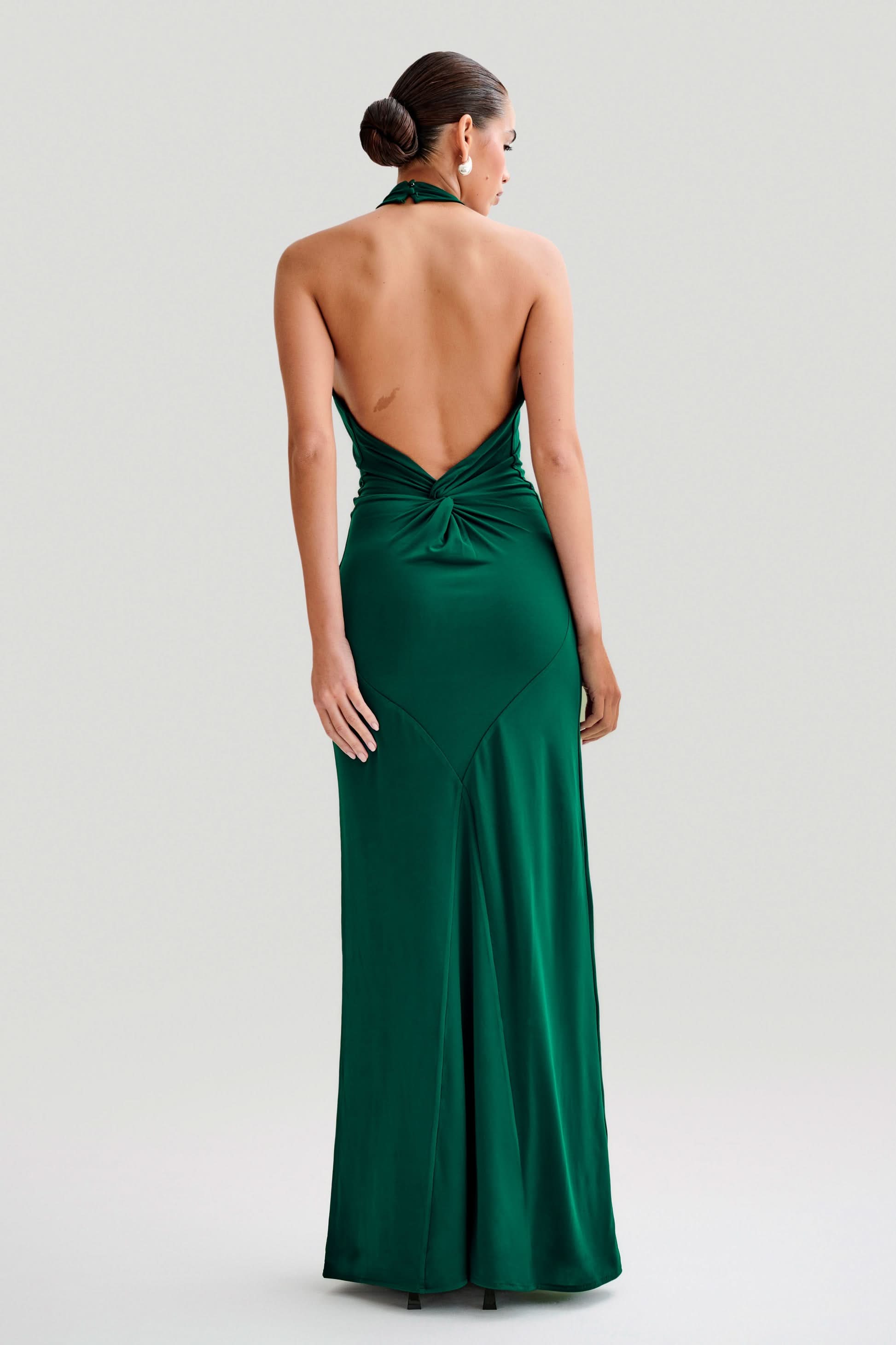 Emerald green halter maxi dress back view with twisted backless cut