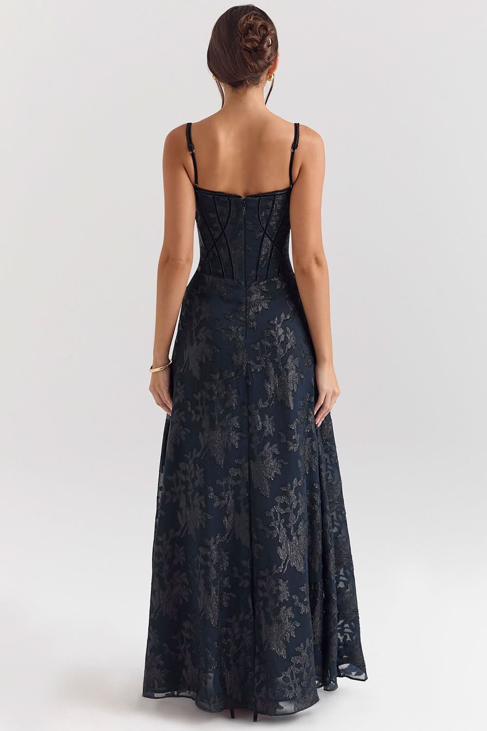 Navy chiffon maxi dress with corset bodice styled with champagne glass