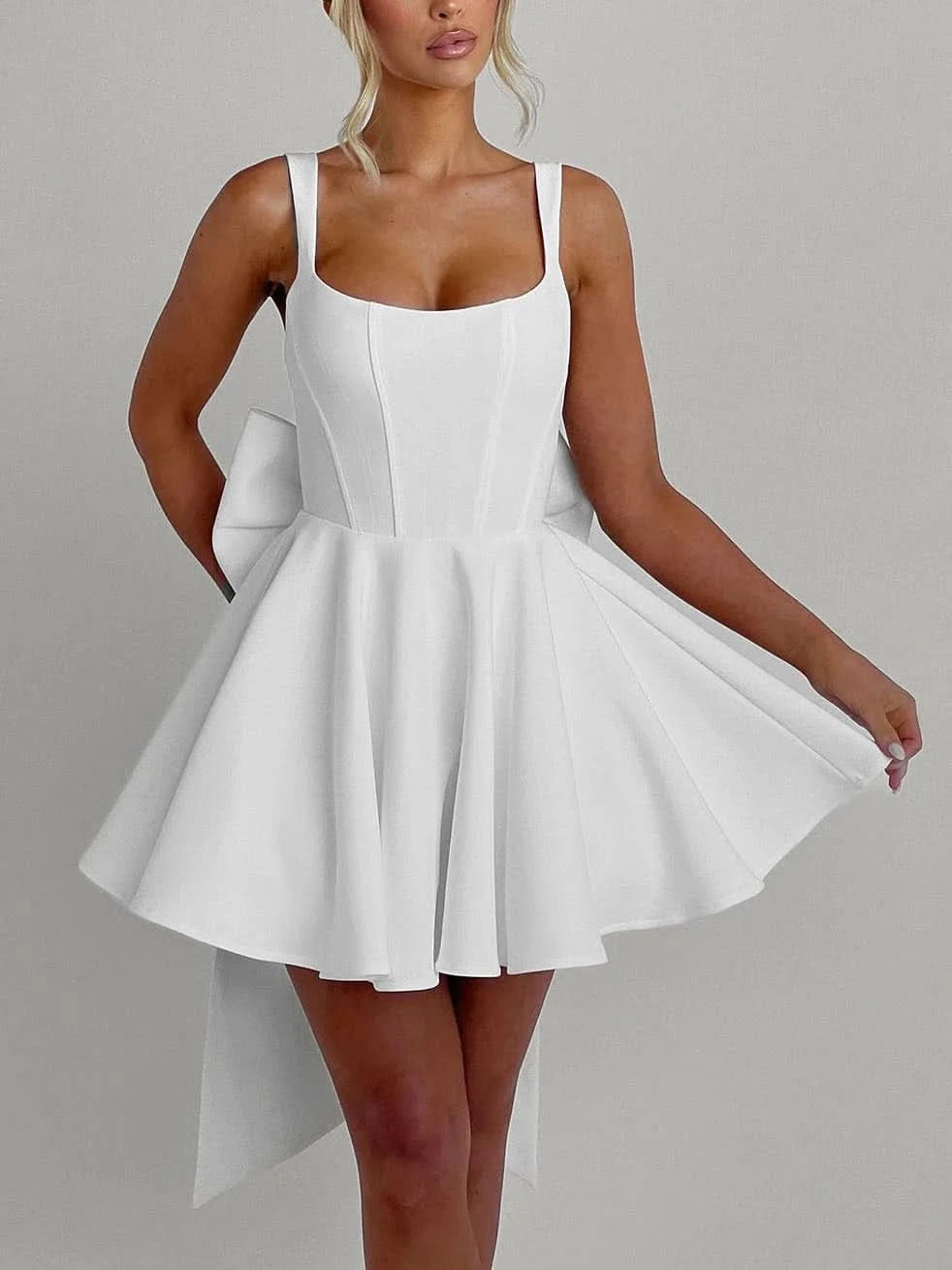 White mini dress with structured bodice and asymmetrical tail hem detail