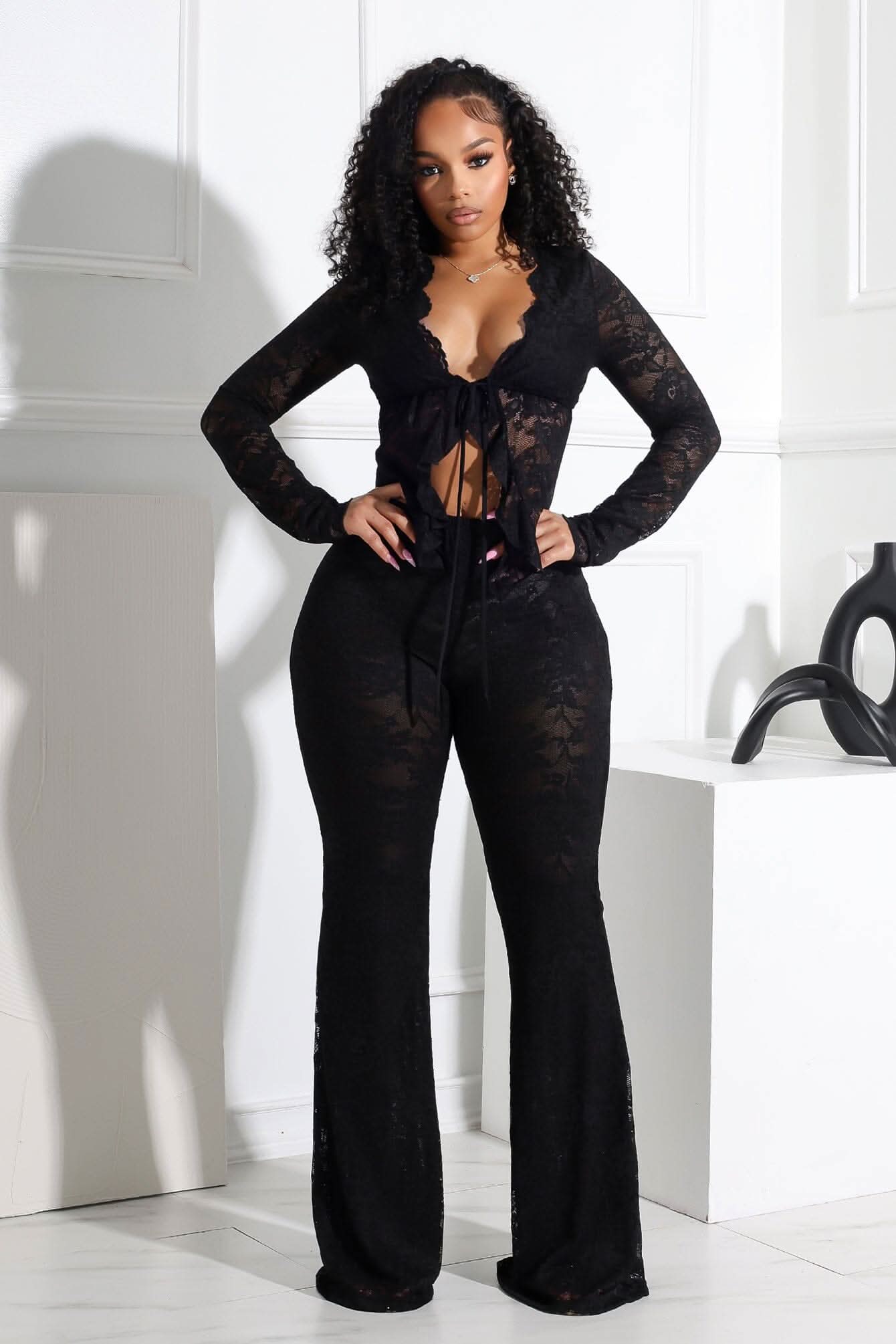 Black lace long-sleeve bodysuit with tie-front and flared leg design