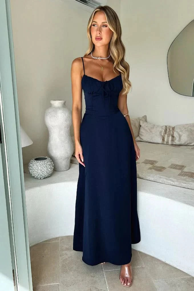 Navy blue spaghetti strap maxi dress with fitted bodice and flowing floor-length skirt