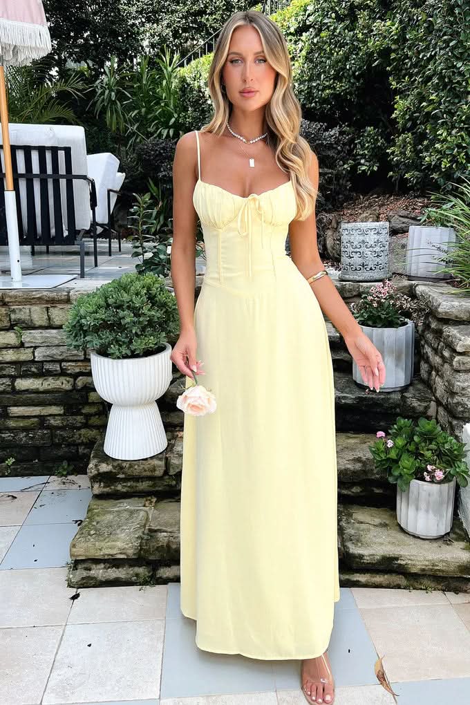 Pale yellow maxi dress with sweetheart neckline outdoor setting