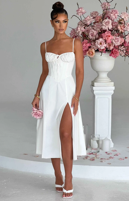 White maxi dress with ruched bustier top and side slit