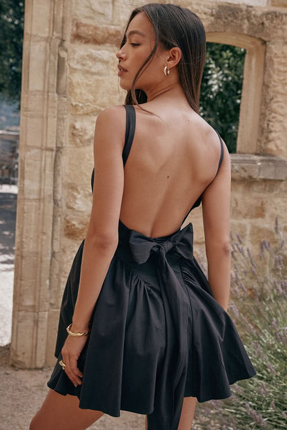 Black backless bow mini dress with halter neckline and full skirt