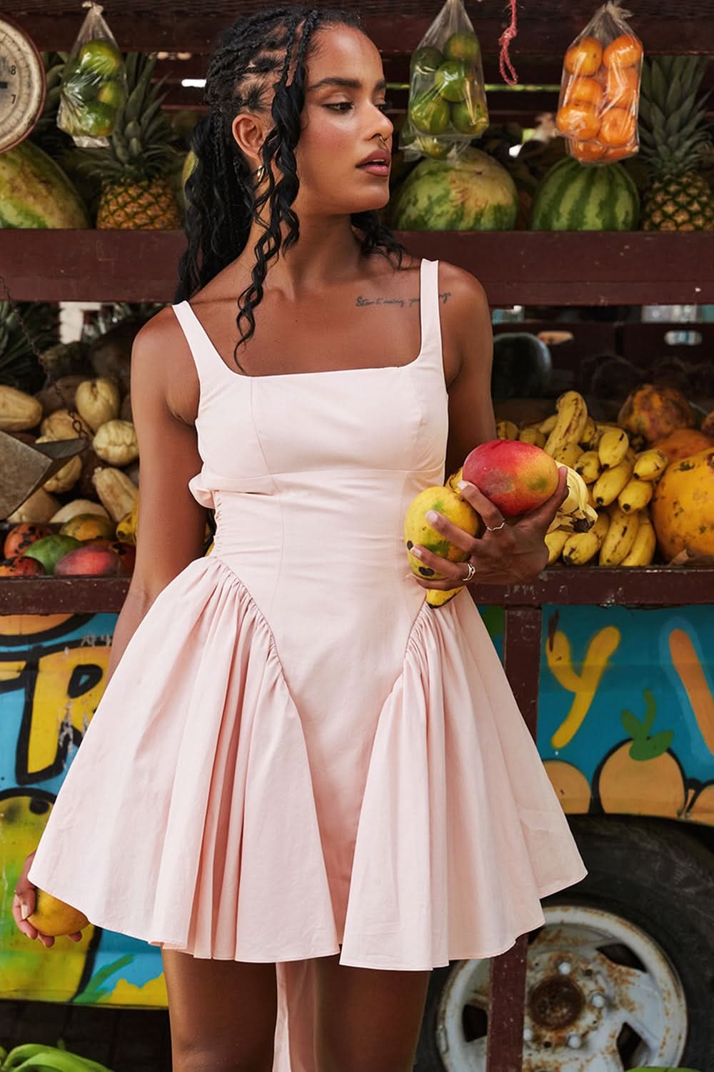 Blush pink bow mini dress with square neckline and pleated skirt