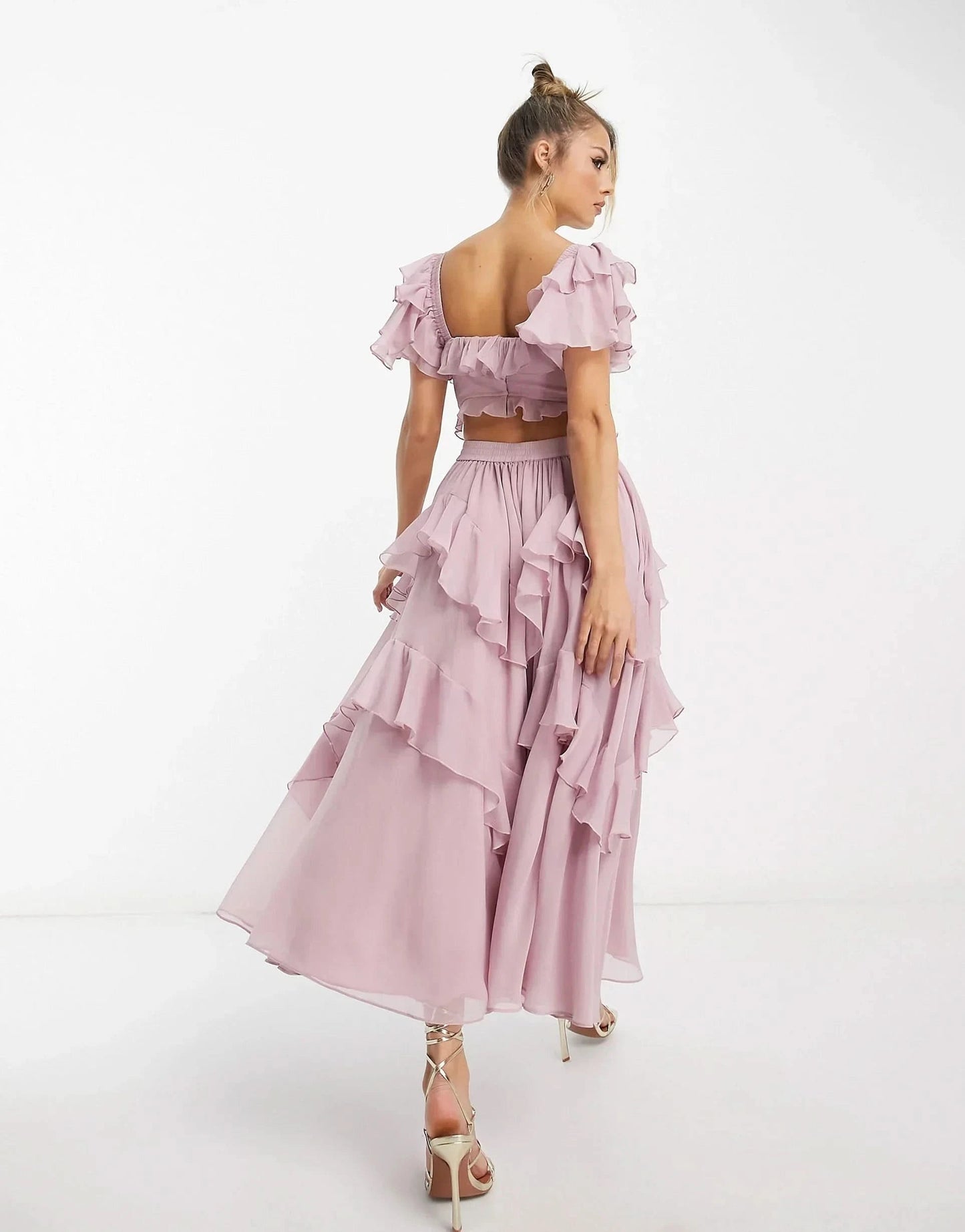 Back view of pink ruffle midi dress with open back and cascading ruffles