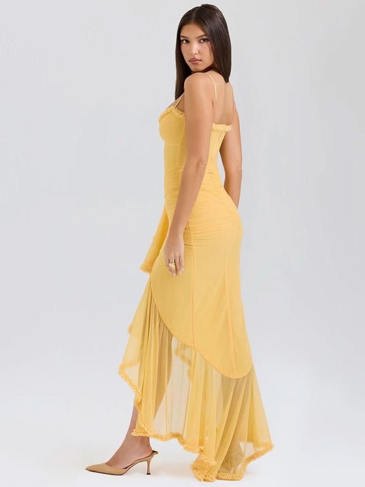 Back view of yellow maxi dress with open back and ruffled train