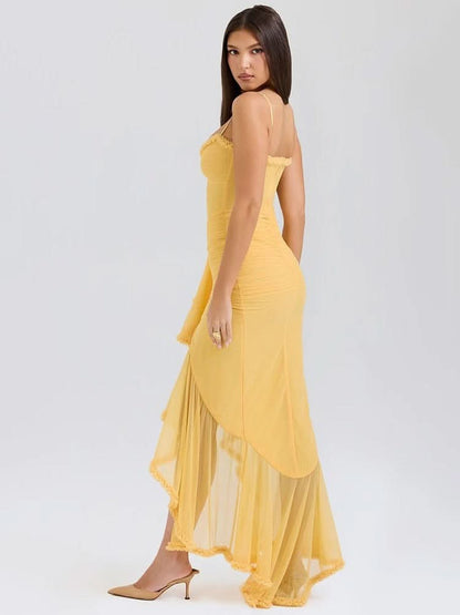 Back view of yellow maxi dress with open back and ruffled train