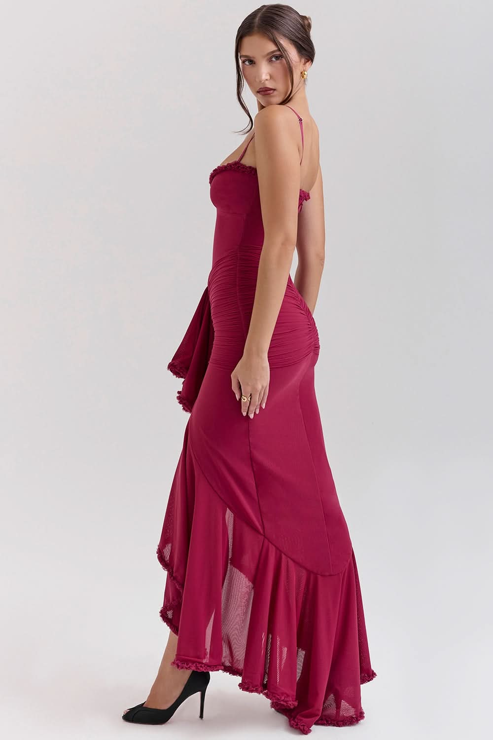Back view of burgundy maxi dress with asymmetrical ruffled hem detail