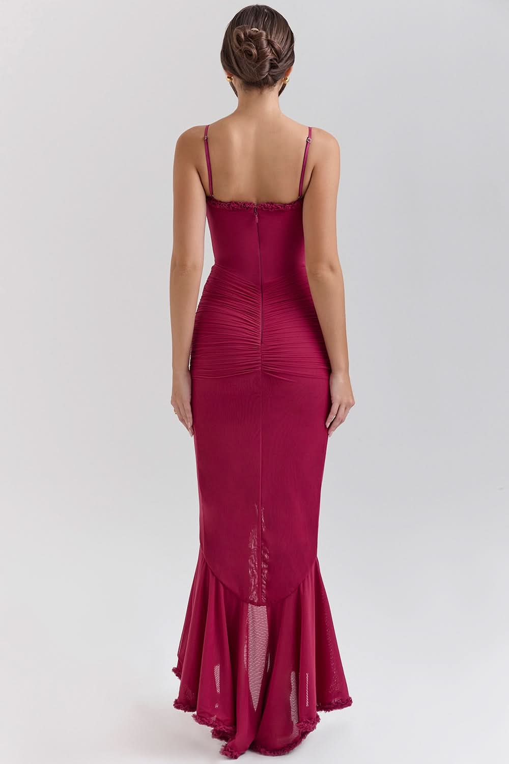 Rear view of burgundy ruffled maxi dress showing back seam and ruching