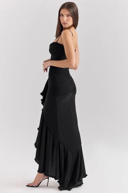 Side view of black maxi dress with cascading ruffled skirt detail