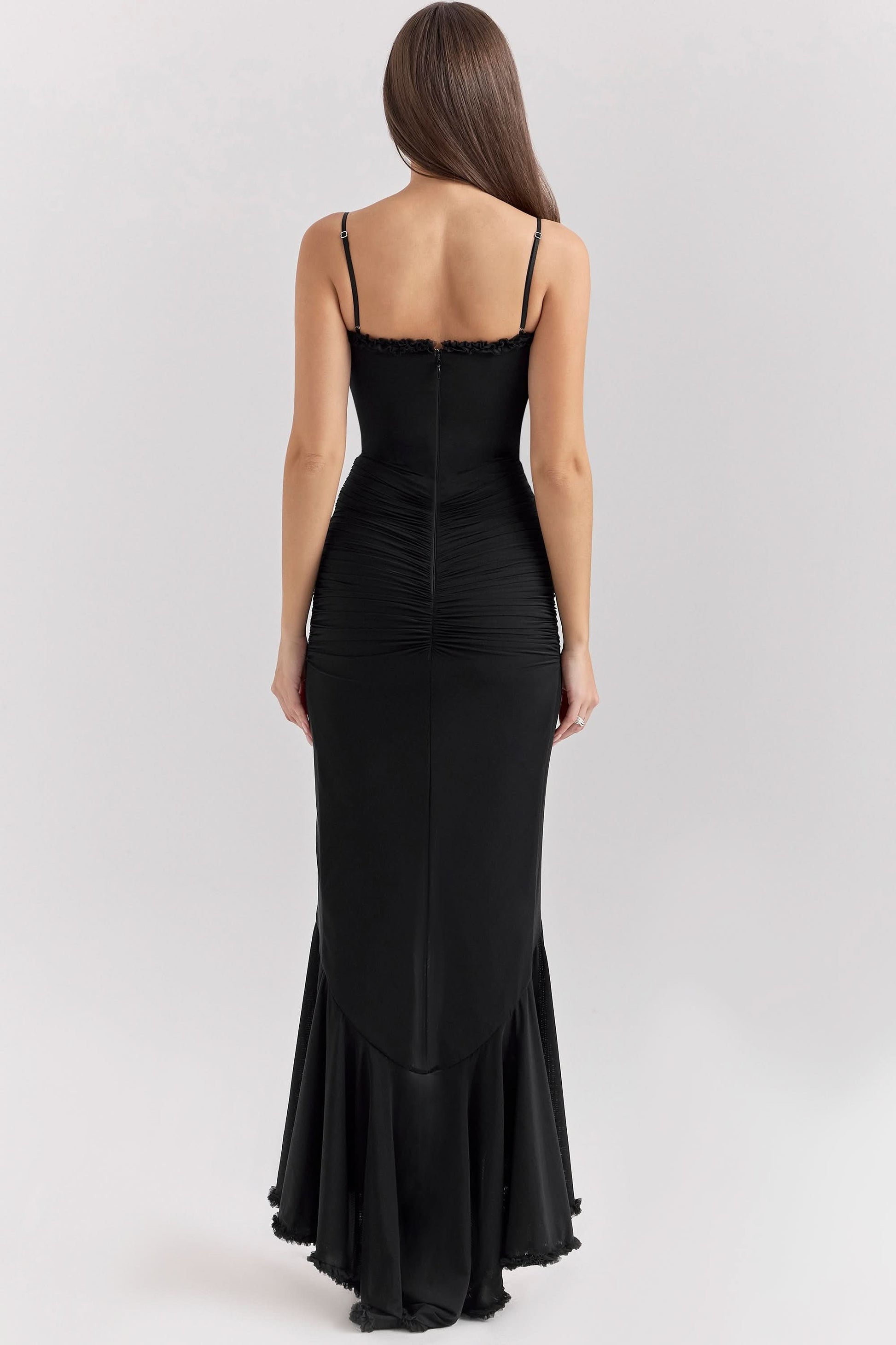 Back view of black ruffled maxi dress with flowing asymmetrical hem