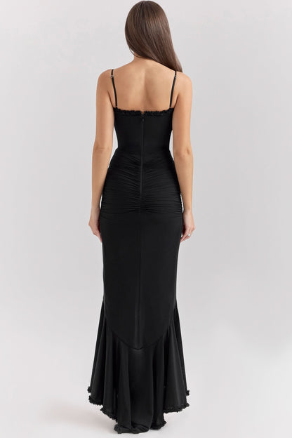 Back view of black ruffled maxi dress with flowing asymmetrical hem
