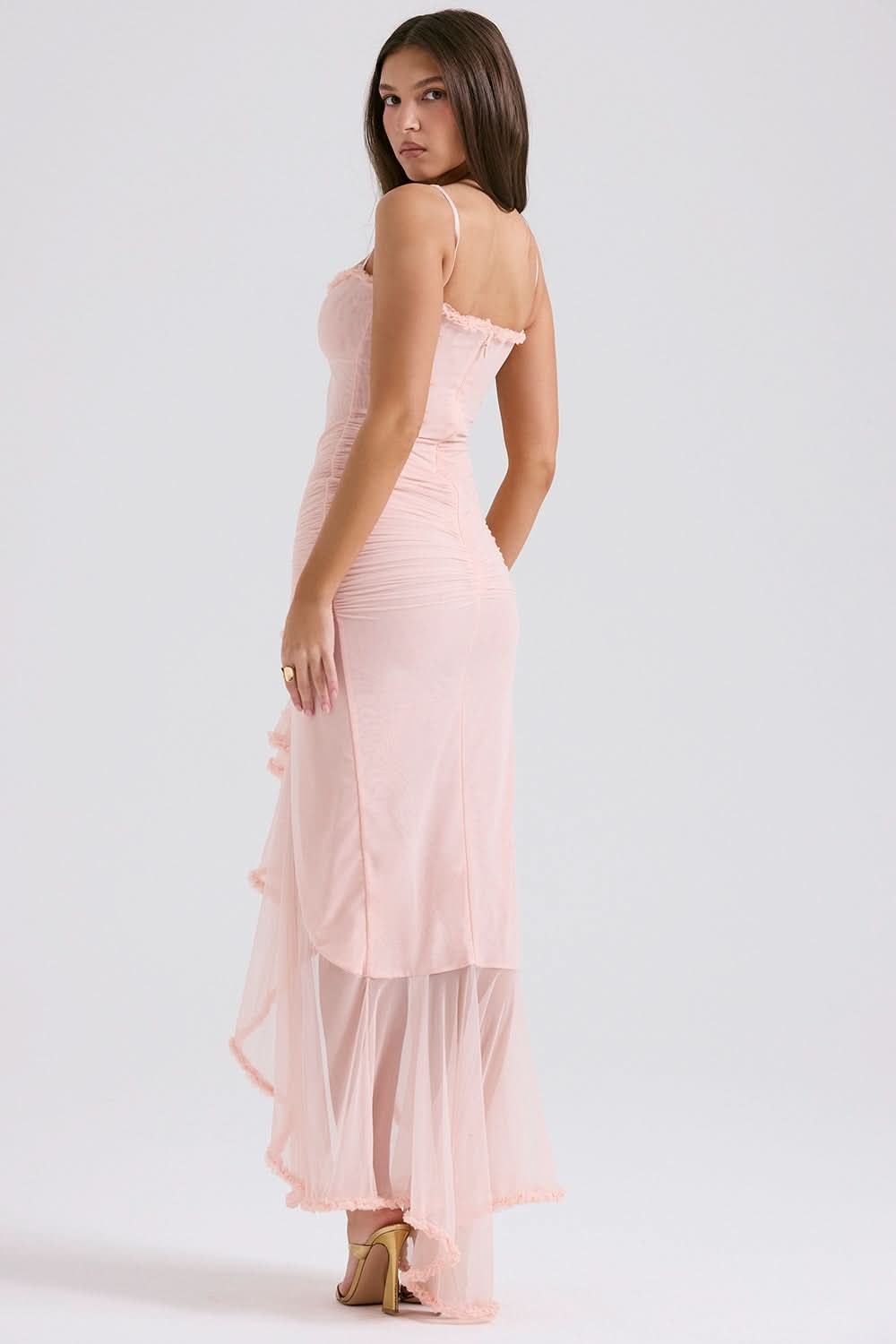Back view of blush pink maxi dress showing open back and ruched fabric detail