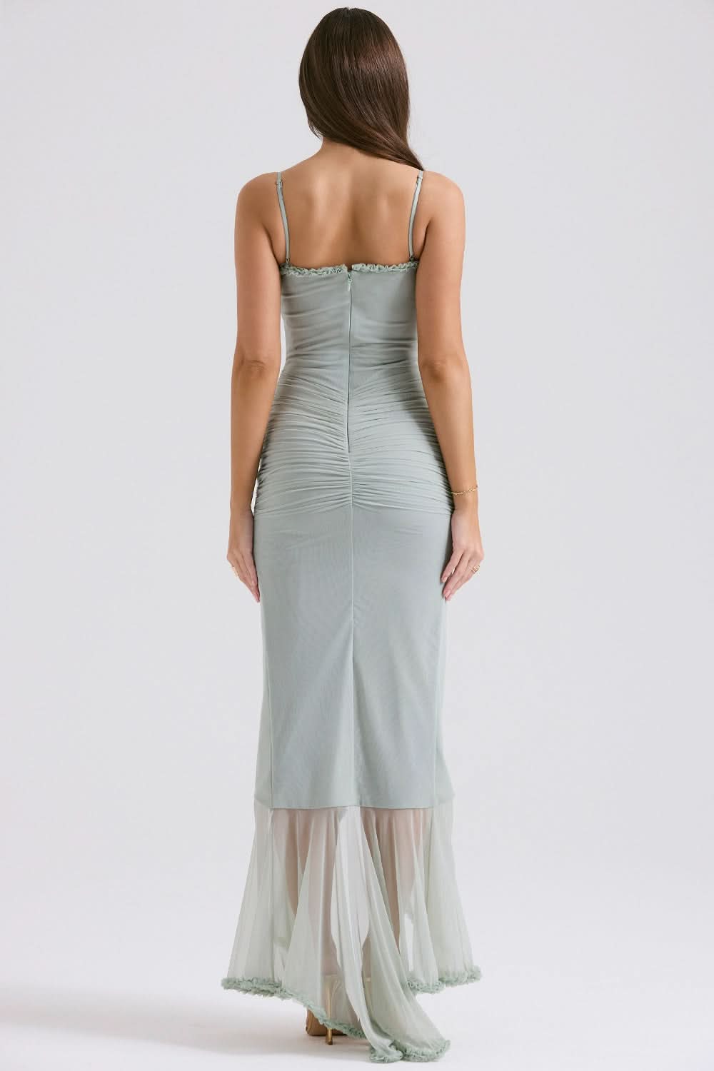 Back view of sage green maxi dress showing open back and ruched bodice detail