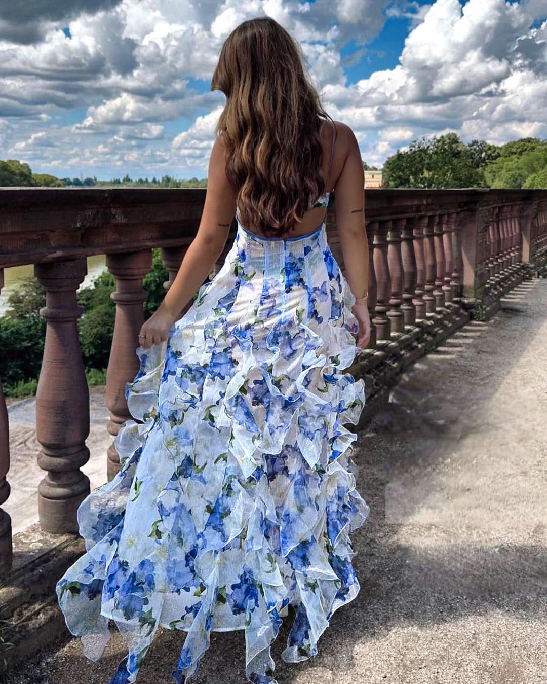 Full-length view of white blue floral maxi dress with cascading ruffles for women