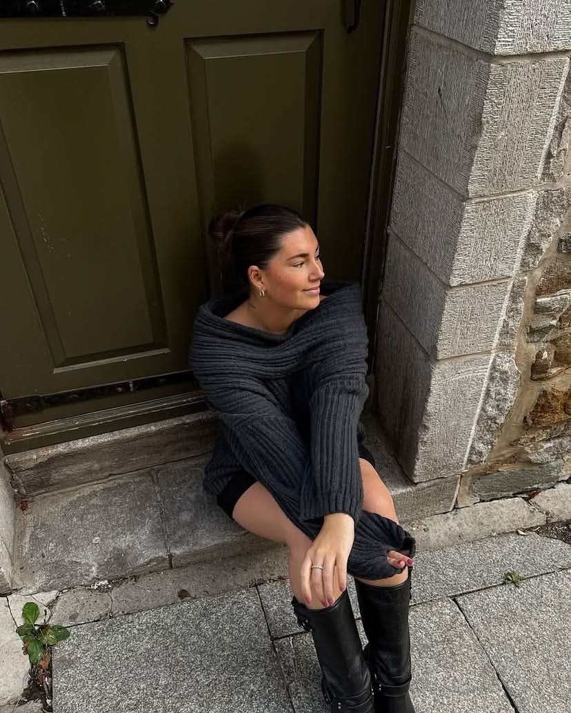 Dark charcoal ribbed sweater with oversized cowl collar worn off-shoulder