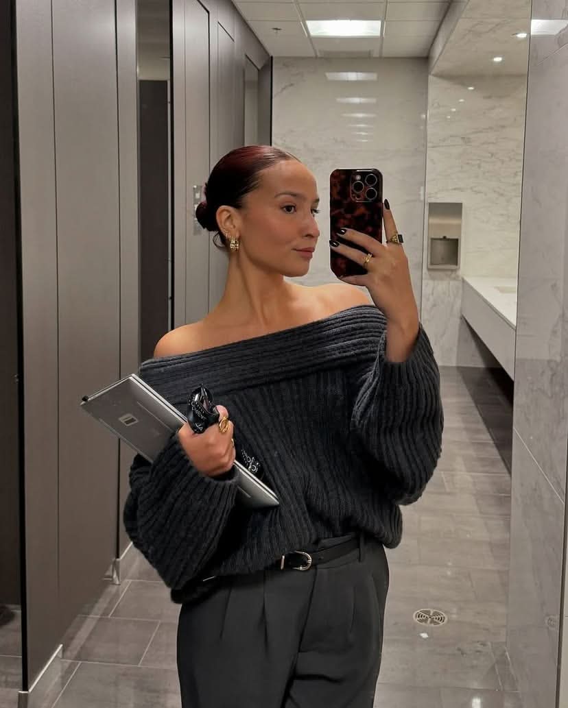 Charcoal gray ribbed sweater with draped off-shoulder neckline detail