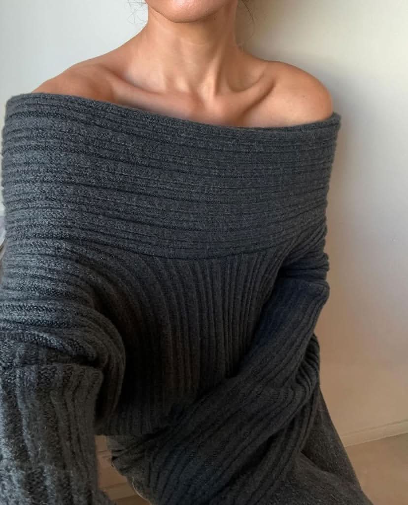 Close-up of gray ribbed sweater fabric showing texture and off-shoulder drape