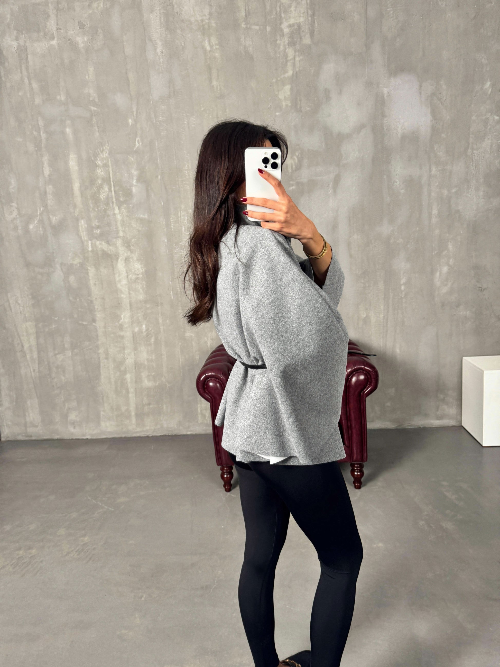 Gray belted poncho jacket back view with structured shoulders and tie belt