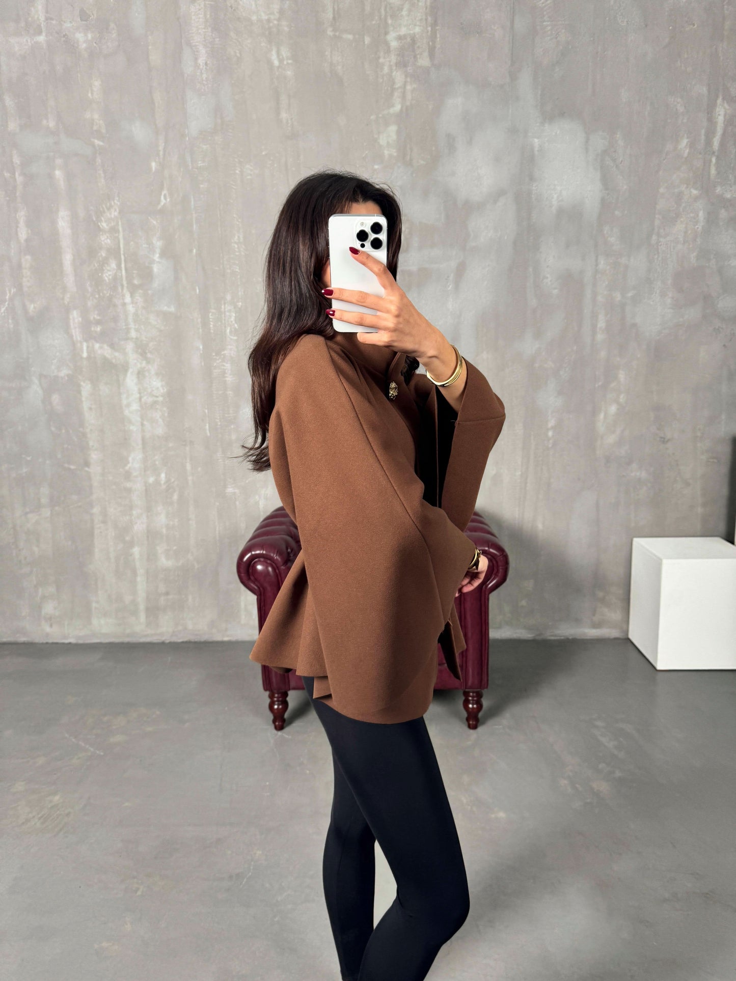 Camel brown poncho jacket side profile with brown leather belt accent