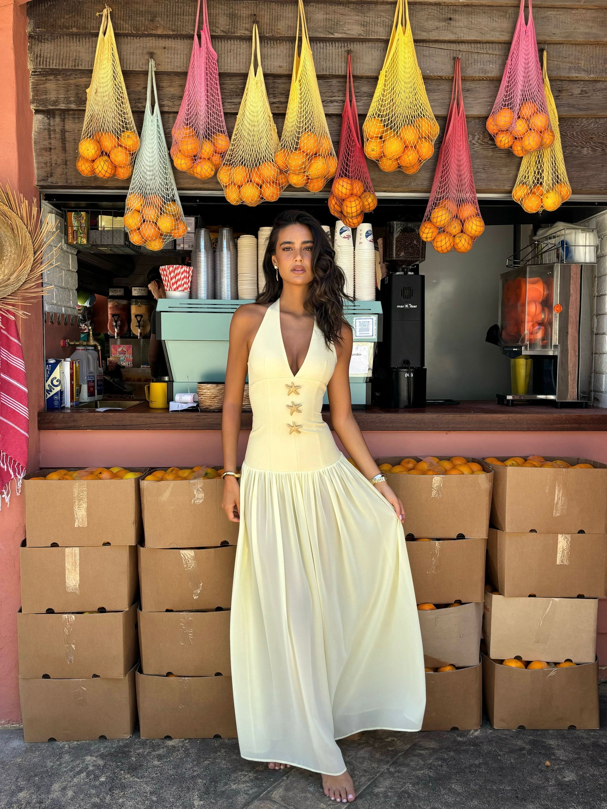 Cream halter maxi dress with gold starfish details and flowing skirt