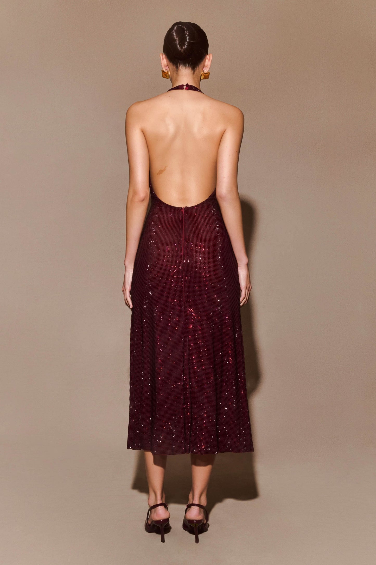 Back view of burgundy sequin maxi dress showing open backless design