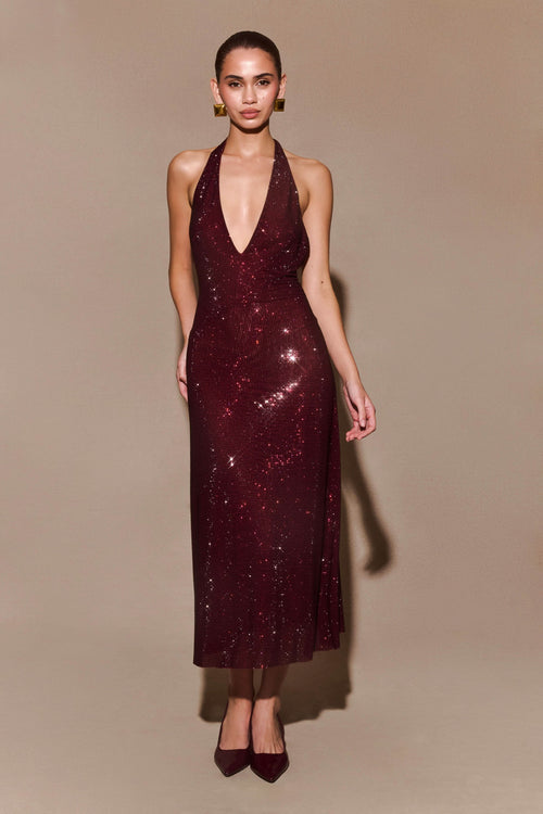 Burgundy sequin halter maxi dress with deep V-neckline and fitted silhouette