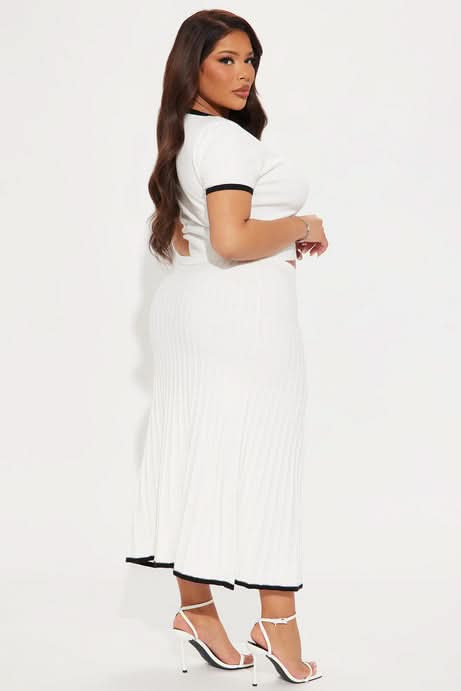 Side view of white ribbed two-piece set showing crop top and midi skirt silhouette