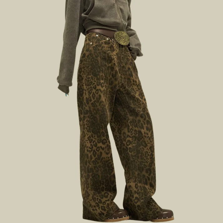 Side view of women's leopard print high waisted wide leg denim pants with studded hem