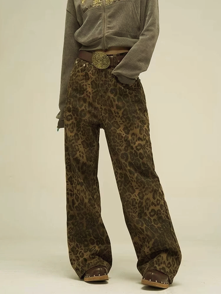 Model wearing olive leopard print wide leg pants with studs and high waist, front view