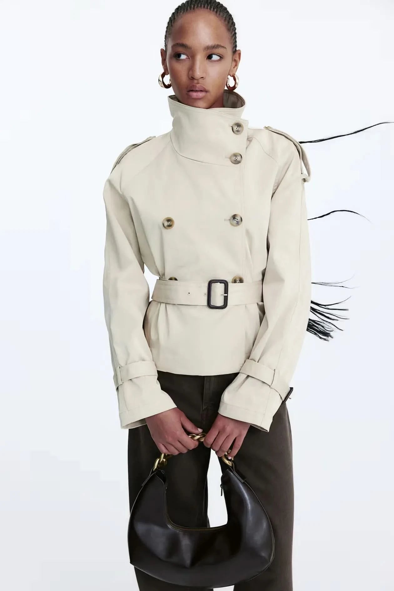 Cream short trench coat with double-breasted buttons and belted waist